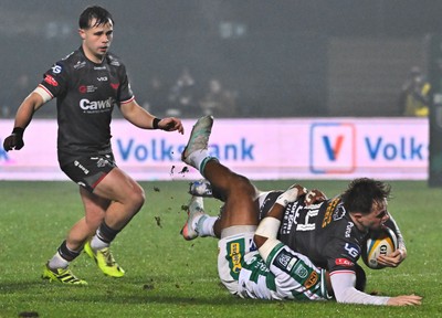 300126 - Benetton Rugby v Scarlets, United Rugby Championship - Macs Page of Scarlets is tackled by Paolo Odogwu of Benetton Rugby as Carwyn Leggatt-Jones of Scarlets supports