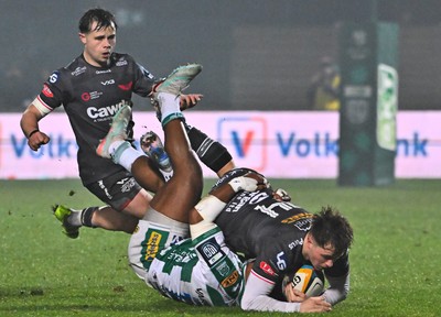 300126 - Benetton Rugby v Scarlets, United Rugby Championship - Macs Page of Scarlets is tackled by Paolo Odogwu of Benetton Rugby as Carwyn Leggatt-Jones of Scarlets supports