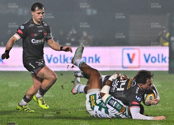 300126 - Benetton Rugby v Scarlets, United Rugby Championship - Macs Page of Scarlets is tackled by Paolo Odogwu of Benetton Rugby as Carwyn Leggatt-Jones of Scarlets supports