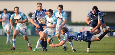 19.11.11 - Benetton Treviso v Ospreys - Heineken Cup - Shane Williams of Ospreys beats the tackle of Benjamin De Jager of Benetton Treviso. 