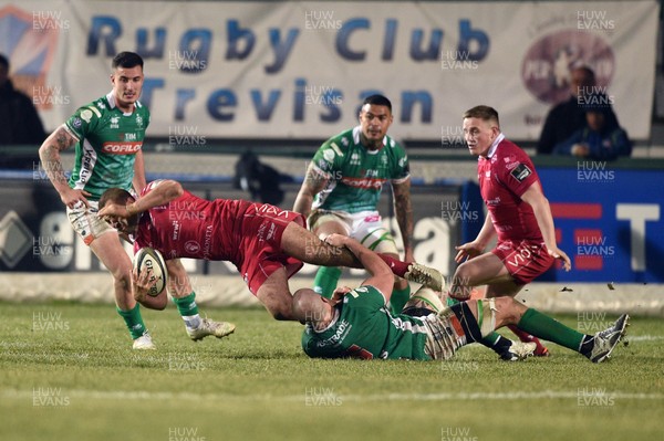 160219 - Benetton Rugby v Scarlets - Guinness PRO14 -  Paul Asquith is tackled by Marco Lazzaroni