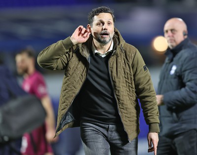 100424 - Birmingham City v Cardiff City - Sky Bet Championship - Manager Erol Bulut of Cardiff playfully listens to the travelling fans cheers