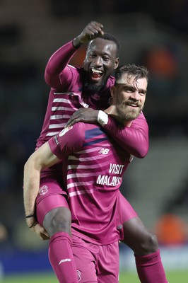 100424 - Birmingham City v Cardiff City - Sky Bet Championship - Famara Diedhiou of Cardiff hitches a lift on the back of Demitrios Goutas of Cardiff at the end of the match