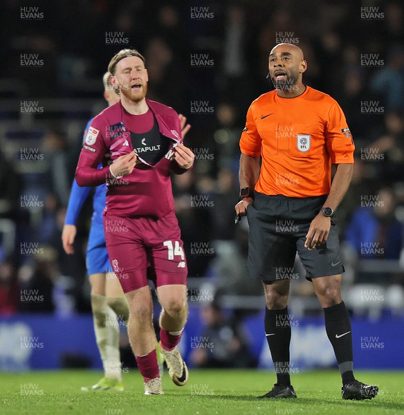 100424 - Birmingham City v Cardiff City - Sky Bet Championship - Jordan James of Birmingham City with torn shirt while ref holds up a yellow card to the Birmingham player