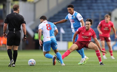 101026 - Blackburn Rovers v Cardiff City - Sky Bet Championship - Joel Colwill of Cardiff tries to grab the ball away from Sam Morsy of Blackburn and Kristi Montgomery of Blackburn