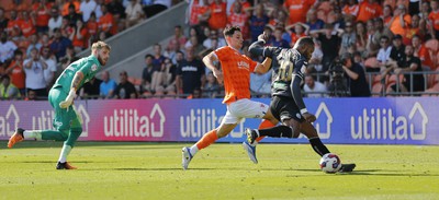 130822 - Blackpool v Swansea City - Sky Bet Championship - Olivier Ntcham of Swansea leaves Goalkeeper Daniel Grimshaw of Blackpool and Rhys Williams of Blackpool behind as he scores 1st goal of the match