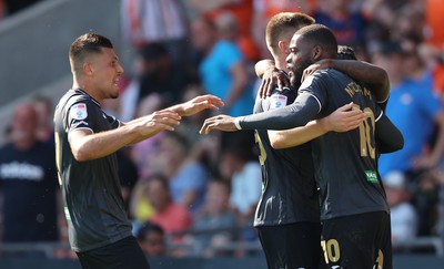 130822 - Blackpool v Swansea City - Sky Bet Championship - Olivier Ntcham of Swansea celebrates scoring the 1st goal of the match with assister Michael Obafemi, Cameron Congreve and Joel Piroe