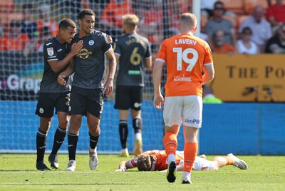 130822 - Blackpool v Swansea City - Sky Bet Championship - Ben Cabango of Swansea heads off a goal challenge and is congratulated by Joel Latibeaudiere of Swansea