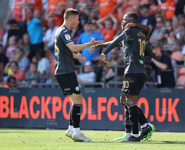 130822 - Blackpool v Swansea City - Sky Bet Championship - Olivier Ntcham of Swansea celebrates scoring the 1st goal of the match with assister Michael Obafemi and Cameron Congreve