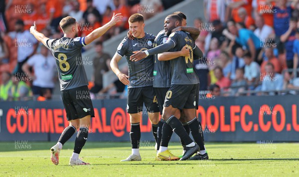 130822 - Blackpool v Swansea City - Sky Bet Championship - Olivier Ntcham of Swansea celebrates scoring the 1st goal of the match with assister Michael Obafemi, Cameron Congreve, Joel Piroe and captain Matt Grimes