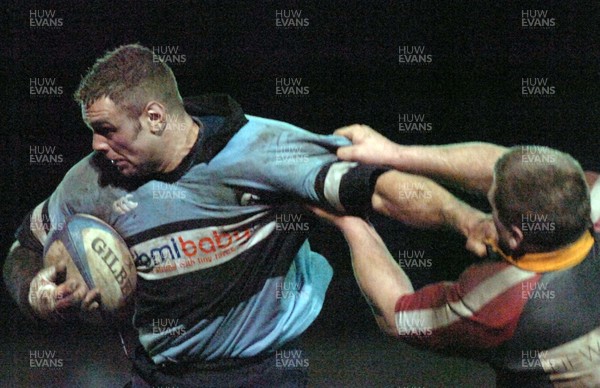 140206 - Amateur Blues v Dragons Amateur - Beddau RFC Blues' Rob Downes holds off the Dragons defence 