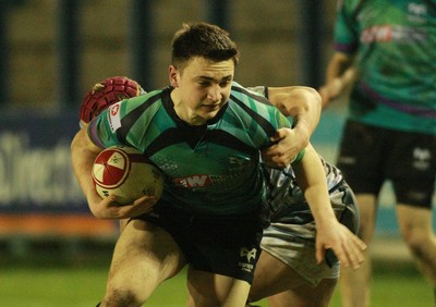 290212 Cardiff Blues South U16 v Ospreys U16 - Regional Age Grade Competition Final -Ospreys' Niall Popham tries to escape the tackle of Blues' Bradley Mais 