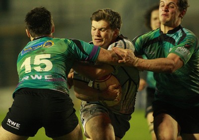 290212 Cardiff Blues South U16 v Ospreys U16 - Regional Age Grade Competition Final -Blues' Harry Roberts is tackled by Ospreys' Lewis Evans(15) and Jo Thomas