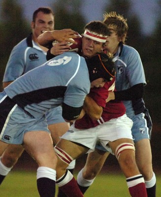 060906 - Blues Under 18 v Scarlets Under 18 - Scarlets Iwan Davies is held by the Blues defence 