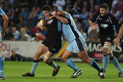 220906 - Cardiff Blues v Glasgow Warriors -  Magners League - Glasgow's John Beattie is tackled by Toufaao Filise 