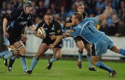 220906 - Cardiff Blues v Glasgow Warriors -  Magners League - Glasgow's Graeme Beveridge is tackled by Gethin Jenkins 