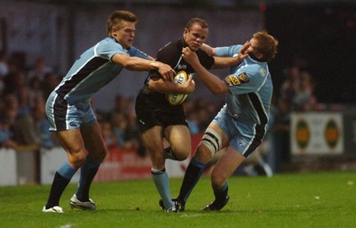 220906 - Cardiff Blues v Glasgow Warriors -  Magners League - Glasgow's Hefin O'Hare is tackled by Chris Czekaj(lt) and Rhys thomas 