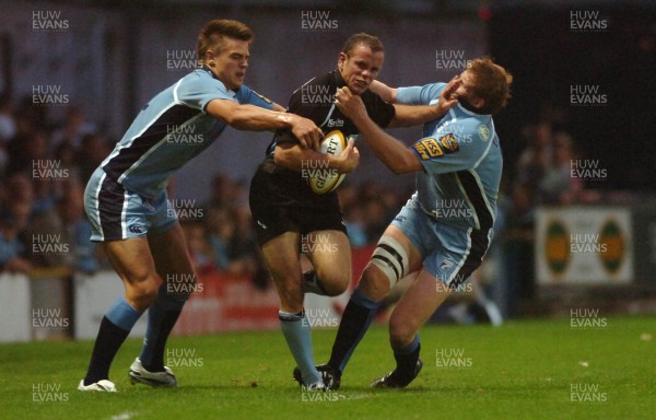 220906 - Cardiff Blues v Glasgow Warriors -  Magners League - Glasgow's Hefin O'Hare is tackled by Chris Czekaj(lt) and Rhys thomas 