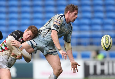 05.02.12 - Cardiff Blues v Harlequins, LV= Cup -.Blues T Rhys Thomas offloads as he's tackled by Harlequins Rory Clegg .