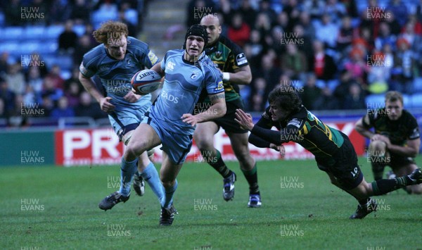 28.03.09...Cardiff Blues v Northampton... Blues Tom James beats tackle by Lee Dickson.. 