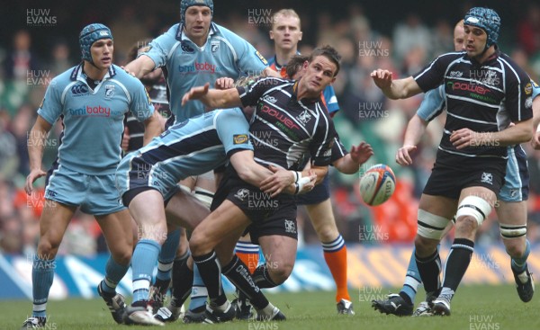 24.03.07 -  Ospreys v Cardiff Blues - EDF Energy Cup Semi-Final - Ospreys Lee Byrne is tackled by Jamie Robinson 