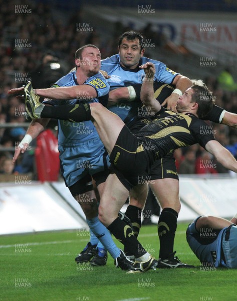 24.10.09 Cardiff Blues v Ospreys - Magners League -  Ospreys' Shane Williams clears the ball under pressure from Richie Rees. 