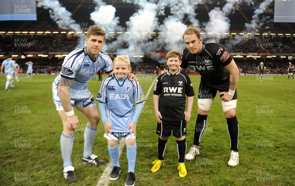 300313 - Cardiff Blues v Ospreys - RaboDirect PRO12 - Gavin Evans of Cardiff Blues and Alun Wyn Jones of Ospreys with their team mascots 