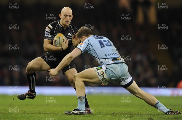 300313 - Cardiff Blues v Ospreys - RaboDirect PRO12 - Richard Fussell of Ospreys is tackled by Gavin Evans of Cardiff Blues 