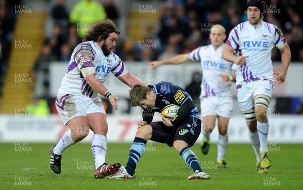 31.12.10 - Cardiff Blues v Ospreys - Magners League - Richard Mustoe of Cardiff Blues is tackled by Adam Jones of Ospreys. 