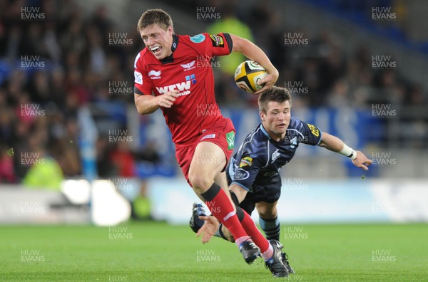 22.10.10 - Cardiff Blues v Scarlets - Magners League - Rhys Priestland of Scarlets gets past Ceri Sweeney of Blues. 