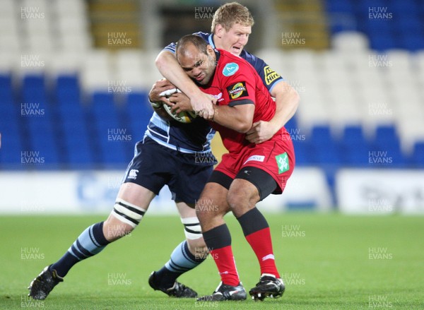 22.10.10.. Cardiff Blues v Scarlets, Magners League -  Scarlets' Deacon Manu is held by Cardiff Blues' Bradley Davies 