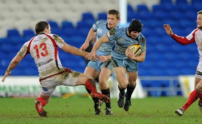 26.03.10 - Cardiff Blues v Ulster - Magners League - Ulster's Darren Cave trips Blues' Leigh Halfpenny. 