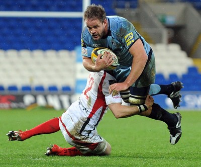 26.03.10 - Magners League Rugby, Cardiff Blues v Ulster Rugby Blues' Xavier Rush is tackled by Ulster's Paddy Wallace 