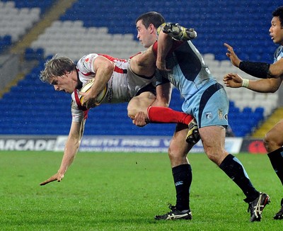 26.03.10 - Magners League Rugby, Cardiff Blues v Ulster Rugby Ulster's Andrew Trimble is tackled by Blues' Dafydd Hewitt 