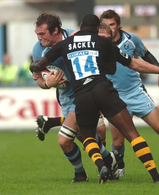 300906 - Cardiff Blues v London Wasps - EDF Energy Cup - Cardiff Arms Park - Cardiff Blues' Robert Sidoli is tackled by Paul Sackey 