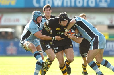 300906  Cardiff Blues v Wasps  Wasps James Haskell  is tackled by Mike Phillips and Scott Morgan  