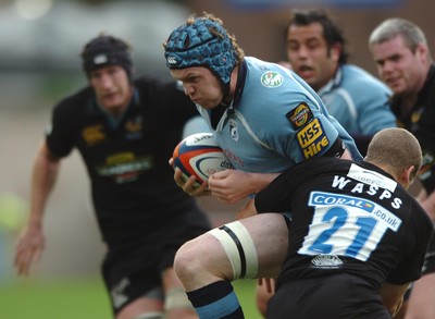 300906  Cardiff Blues v Wasps   Blues James Goode powers through Dave Walder  