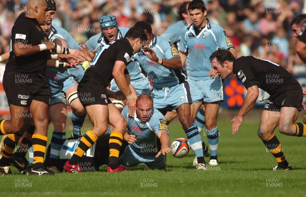 300906 - Cardiff Blues v London Wasps - EDF Energy Cup - Cardiff Arms Park - Cardiff Blues' Mark Lewis loses the ball as he is tackled by Eoin Reddan 