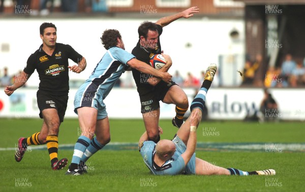 300906 - Cardiff Blues v London Wasps - EDF Energy Cup - Cardiff Arms Park - Wasps Fraser Waters is tackled by Tom Shanklin and Nick Macleod(lt) 