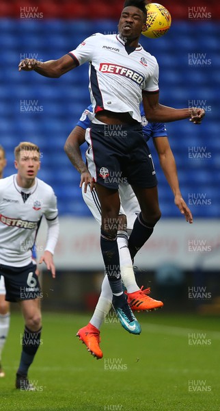231217 - Bolton Wanderers v Cardiff City - SkyBet Championship - Sammy Ameobi of Bolton heads away from Nathaniel Mendez-Laing of Cardiff