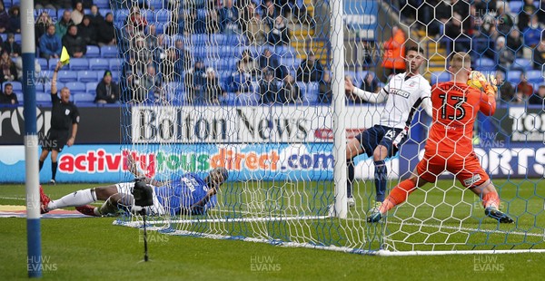 231217 - Bolton Wanderers v Cardiff City - SkyBet Championship - Ben Alnwick of Bolton saves from Sol Bamba of Cardiff