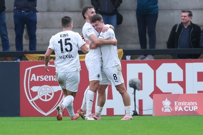 071225 - Boreham Wood v Newport County, Emirates FA Cup 2nd Round - Regan Booty of Boreham Wood, centre, celebrates with team mates after scoring the second goal