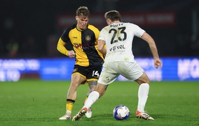071225 - Boreham Wood v Newport County, Emirates FA Cup 2nd Round - Kai Whitmore of Newport County takes on Regan Booty of Boreham Wood