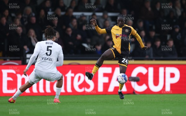 071225 - Boreham Wood v Newport County, Emirates FA Cup 2nd Round - Nathan Opoku of Newport County takes on Chris Bush of Boreham Wood