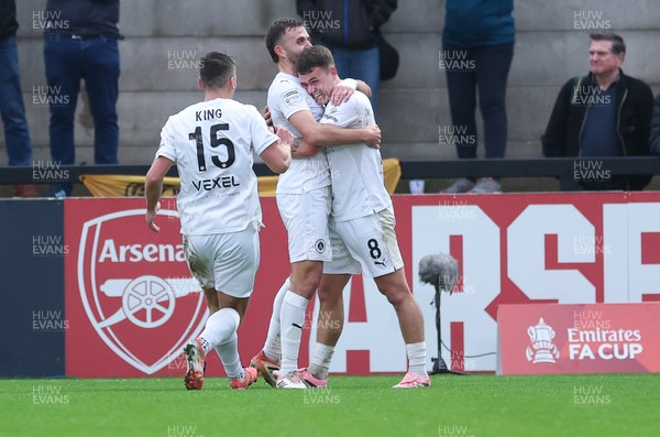 071225 - Boreham Wood v Newport County, Emirates FA Cup 2nd Round - Regan Booty of Boreham Wood, centre, celebrates with team mates after scoring the second goal