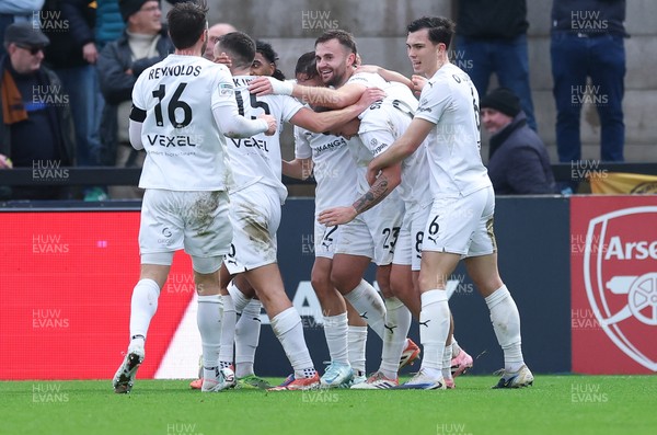 071225 - Boreham Wood v Newport County, Emirates FA Cup 2nd Round - Regan Booty of Boreham Wood, centre, celebrates with team mates after scoring the second goal