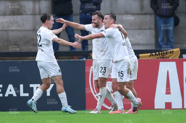 071225 - Boreham Wood v Newport County, Emirates FA Cup 2nd Round - Regan Booty of Boreham Wood, centre, celebrates with team mates after scoring the second goal