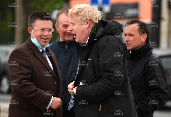 030521 -  Prime Minister Boris Johnson, Matt Smith, Welsh Conservative candidate for the Vale of Glamorgan, Simon Hart MP and Alun Cairns MP during a visit to Marco's Cafe at Barry Island, South Wales as the final week of campaigning for the Senedd elections gets under way