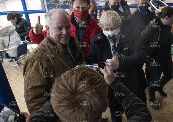 030521 - Picture shows Prime Minister Boris Johnson with Welsh Conservative Leader Andrew RT Davies whilst visiting Marco�s cafe in Barry Island, South Wales on Bank Holiday Monday