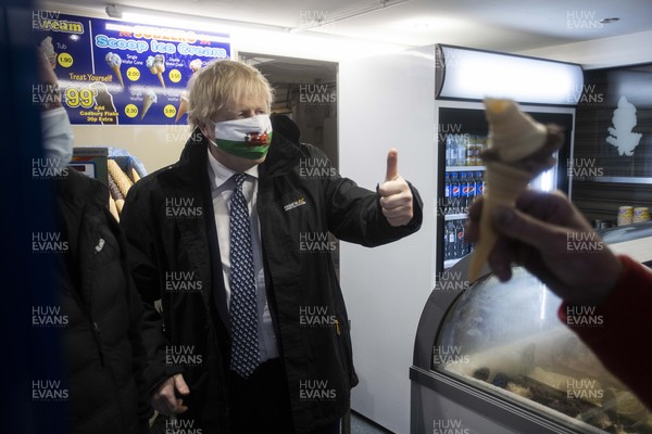 030521 - Picture shows Prime Minister Boris Johnson serving ice cream whilst visiting Marco�s cafe in Barry Island, South Wales on Bank Holiday Monday
